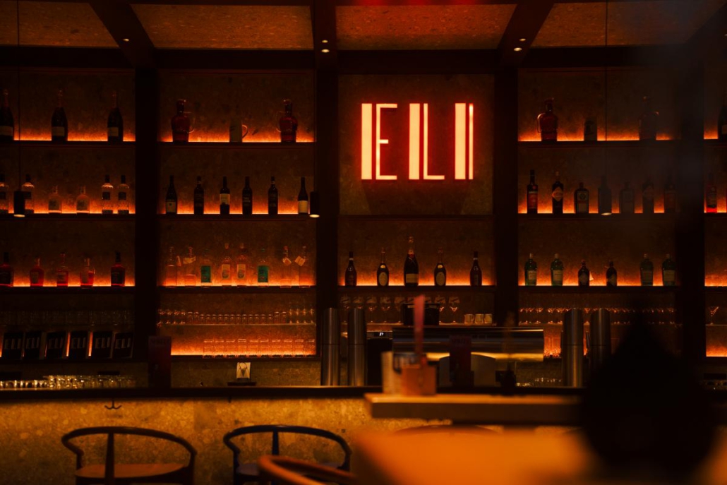 Barbereich des ELI Schwabing mit beleuchtetem ELI-Logo und stilvoller Innenarchitektur.